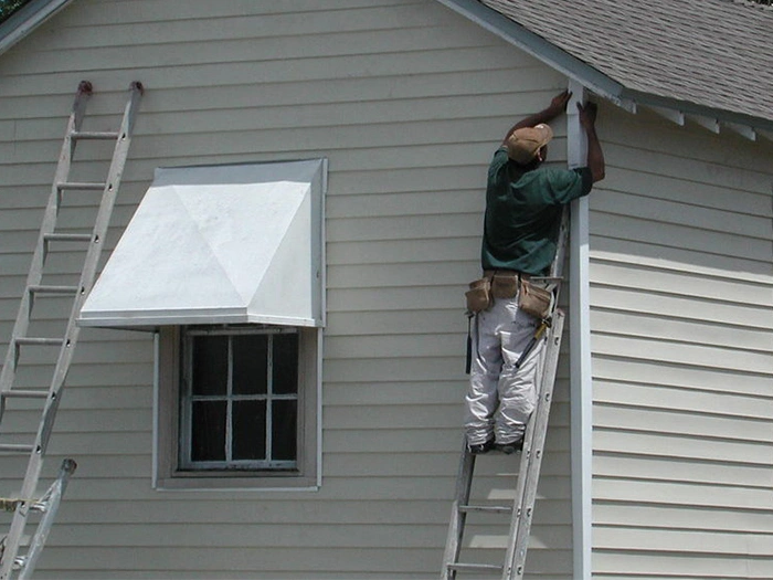 Worker Installing New Gutters